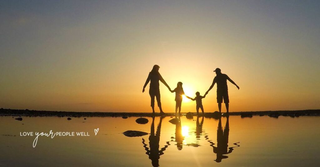 Christian family building relationship by walking on the beach