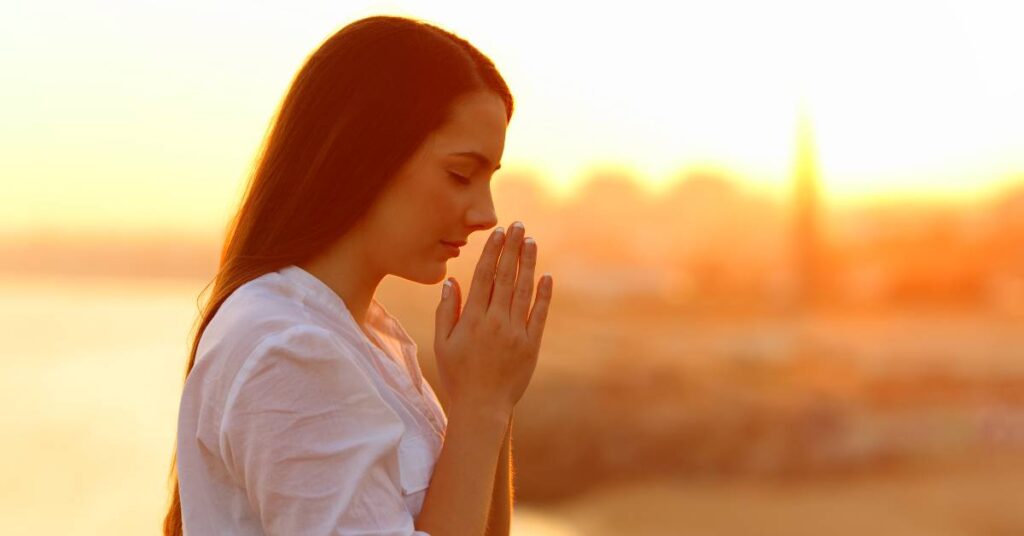 woman praying as she tries to trust God more and stop worrying