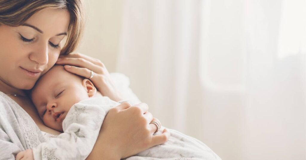 stay at home Christian mom snuggling her baby