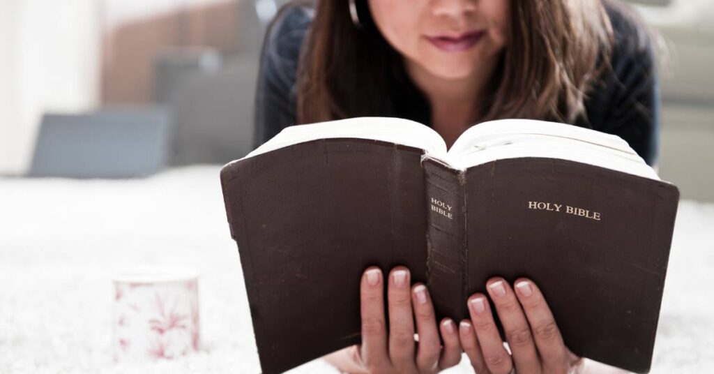 close-up photo of a woman reading her Bible as part of her daily Bible habit