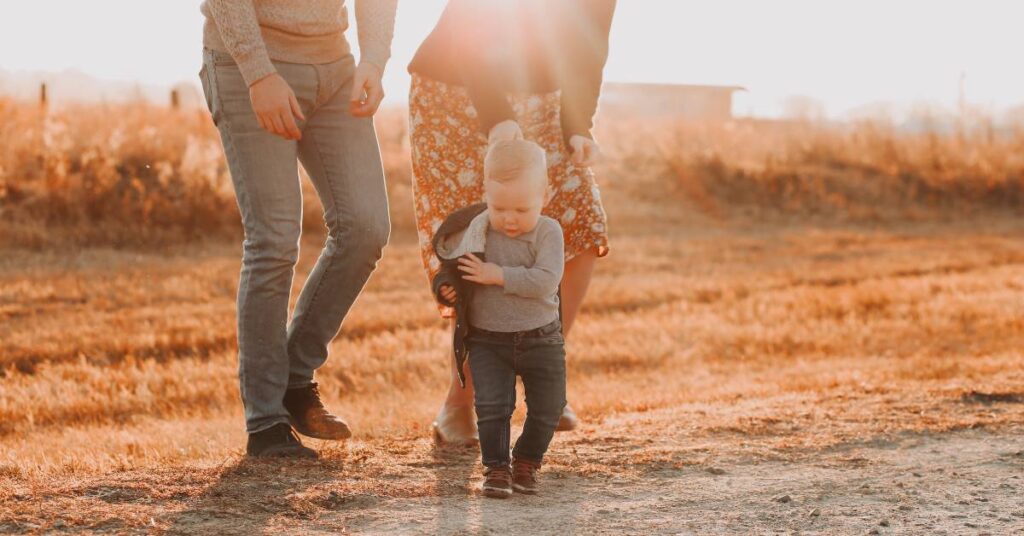 parents and their toddler walking through a field making a daily choice to spend quality time together